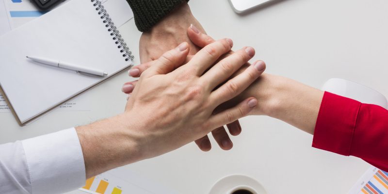 top-view-hands-together-desk top-view-hands-together-desk